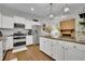 Spacious kitchen with stainless steel appliances, granite countertops, white cabinetry, and eat-in area at 305 River Glen Dr, Roswell, GA 30075