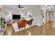 Open living room with hardwood floors, recessed lighting, and a view to kitchen through serving hatch at 305 River Glen Dr, Roswell, GA 30075