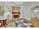 Cozy living room featuring a brick fireplace, hardwood floors, and a welcoming atmosphere for relaxation at 305 River Glen Dr, Roswell, GA 30075
