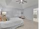 Bright bedroom with white plantation shutters, tray ceiling, and ensuite bathroom at 305 River Glen Dr, Roswell, GA 30075