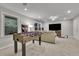 This recreation room has a table game, TV, couch, and windows for ample lighting at 305 River Glen Dr, Roswell, GA 30075