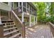 Multi-level back deck with stairs descending into the backyard and surrounded by trees at 3453 Drayton Ne Dr, Roswell, GA 30075