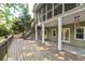 Spacious back deck with stairs leading to the backyard and a screened-in porch above at 3453 Drayton Ne Dr, Roswell, GA 30075