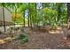 View of backyard with mature trees and lush landscaping at 3453 Drayton Ne Dr, Roswell, GA 30075