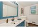Charming bathroom with blue vanity, updated fixtures, and natural light from a large window at 3453 Drayton Ne Dr, Roswell, GA 30075