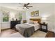 Comfortable bedroom with natural light, ceiling fan, neutral tones, and hardwood floors at 3453 Drayton Ne Dr, Roswell, GA 30075