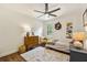 Bright bedroom with a ceiling fan, hardwood floors, and a window overlooking the greenery at 3453 Drayton Ne Dr, Roswell, GA 30075