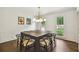 Formal dining room with modern light fixture, wainscotting and views of the backyard at 3453 Drayton Ne Dr, Roswell, GA 30075