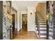 Inviting foyer with hardwood floors, decorative wreaths on the french doors, and a staircase leading to the second floor at 3453 Drayton Ne Dr, Roswell, GA 30075