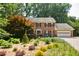 Beautiful traditional brick home with shutters, manicured landscaping, and a two-car garage at 3453 Drayton Ne Dr, Roswell, GA 30075