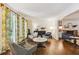 Cozy living room with hardwood floors, fireplace, and large windows offering natural light at 3453 Drayton Ne Dr, Roswell, GA 30075