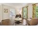 Bright living room showcasing hardwood floors, modern seating, and large windows at 3453 Drayton Ne Dr, Roswell, GA 30075