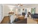 Spacious living room with hardwood floors, fireplace, and a seamless transition to the adjacent sitting area at 3453 Drayton Ne Dr, Roswell, GA 30075