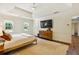 Spacious main bedroom featuring a ceiling fan, a mounted TV, and ensuite access at 3453 Drayton Ne Dr, Roswell, GA 30075