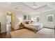 Relaxing main bedroom showcasing a tray ceiling, three windows, and neutral tones at 3453 Drayton Ne Dr, Roswell, GA 30075