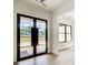 Modern entryway with black framed glass front door and light wood flooring at 520 Rockbridge Rd, Lilburn, GA 30047