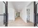 Bright hallway with light wood floors, white walls and black door and hardware at 520 Rockbridge Rd, Lilburn, GA 30047