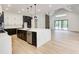 Modern kitchen with large island, stainless appliances and view to the backyard at 520 Rockbridge Rd, Lilburn, GA 30047