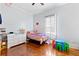 Bright bedroom featuring hardwood floors, a dresser, and a play area at 1081 Longley Nw Ave, Atlanta, GA 30318