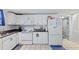 Cozy kitchen featuring granite countertops, white cabinets, and modern appliances at 1081 Longley Nw Ave, Atlanta, GA 30318
