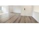 The welcoming living room features recently installed hard flooring that flows into adjacent areas through a french door at 123 Maison Nw Pl, Atlanta, GA 30327
