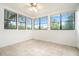 Bright sunroom with large windows, tiled floor and ceiling fan at 123 Maison Nw Pl, Atlanta, GA 30327