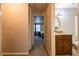 Bathroom view showcasing vanity, shower, mirror and hall access to bedroom at 1406 Springleaf Se Cir, Smyrna, GA 30080