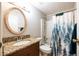 Bathroom featuring a granite sink countertop and blue and white shower curtain at 1406 Springleaf Se Cir, Smyrna, GA 30080