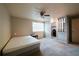 Neutral bedroom featuring a queen bed, a ceiling fan, large window and access to walk-in closet at 1406 Springleaf Se Cir, Smyrna, GA 30080