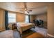 Neutral bedroom featuring a ceiling fan, two windows, and a dedicated desk area at 1406 Springleaf Se Cir, Smyrna, GA 30080