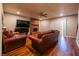 Spacious living room with hardwood floors, brick fireplace, and plenty of natural light at 1406 Springleaf Se Cir, Smyrna, GA 30080