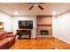 Finished living room featuring a brick fireplace and hardwood floors at 1406 Springleaf Se Cir, Smyrna, GA 30080