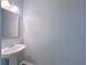Stylish half-bath with a pedestal sink and modern mirror at 1892 Old Dogwood, Jonesboro, GA 30238