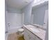Bright bathroom featuring granite countertop, white cabinets, and a shower over tub combination at 1892 Old Dogwood, Jonesboro, GA 30238