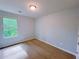 This cozy bedroom offers a neutral color palette, carpet flooring, and a window with natural light at 1892 Old Dogwood, Jonesboro, GA 30238