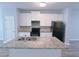 Well-equipped kitchen with granite countertops, white cabinets, and black appliances at 1892 Old Dogwood, Jonesboro, GA 30238