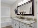 Bathroom with double sinks, granite countertop and framed mirror, providing a luxurious feel at 4180 Gables Pl, Buford, GA 30519