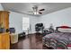Bedroom featuring hardwood floors, a ceiling fan and natural light at 4180 Gables Pl, Buford, GA 30519