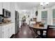 Spacious eat-in kitchen showcasing wood floors, stainless steel appliances, and a bright ambiance at 4180 Gables Pl, Buford, GA 30519