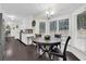 Eat-in kitchen featuring granite countertops, stainless steel appliances, and wood flooring at 4180 Gables Pl, Buford, GA 30519