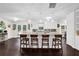 Open kitchen layout with island featuring a breakfast bar, granite counters, and ample cabinet space at 4180 Gables Pl, Buford, GA 30519