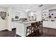 Spacious kitchen features an island with seating, white cabinets, stainless appliances, and hardwood floors at 4180 Gables Pl, Buford, GA 30519