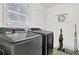 Functional laundry room featuring modern washer and dryer, storage, and natural light at 4180 Gables Pl, Buford, GA 30519