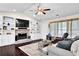 The living room has vaulted ceilings, a fireplace, built-in shelving and large windows at 4180 Gables Pl, Buford, GA 30519