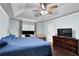 Comfortable main bedroom with a ceiling fan and space for a home office setup at 4180 Gables Pl, Buford, GA 30519