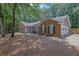 Well-maintained brick home featuring an attached garage, a cozy porch, and a paved walkway at 4180 Gables Pl, Buford, GA 30519