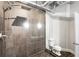 Shower with gray tile and a glass door, including a view of the toilet at 878 Peachtree Ne St # 704, Atlanta, GA 30309