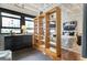 Bright bedroom featuring a wooden bookshelf room divider, large windows, and comfortable furnishings at 878 Peachtree Ne St # 704, Atlanta, GA 30309
