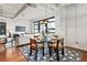 Bright and inviting dining area adjacent to the living room with a modern table set and large windows at 878 Peachtree Ne St # 704, Atlanta, GA 30309