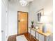 Inviting entryway with hardwood floors, stylish lighting, and a charming accent table with decorative elements at 878 Peachtree Ne St # 704, Atlanta, GA 30309